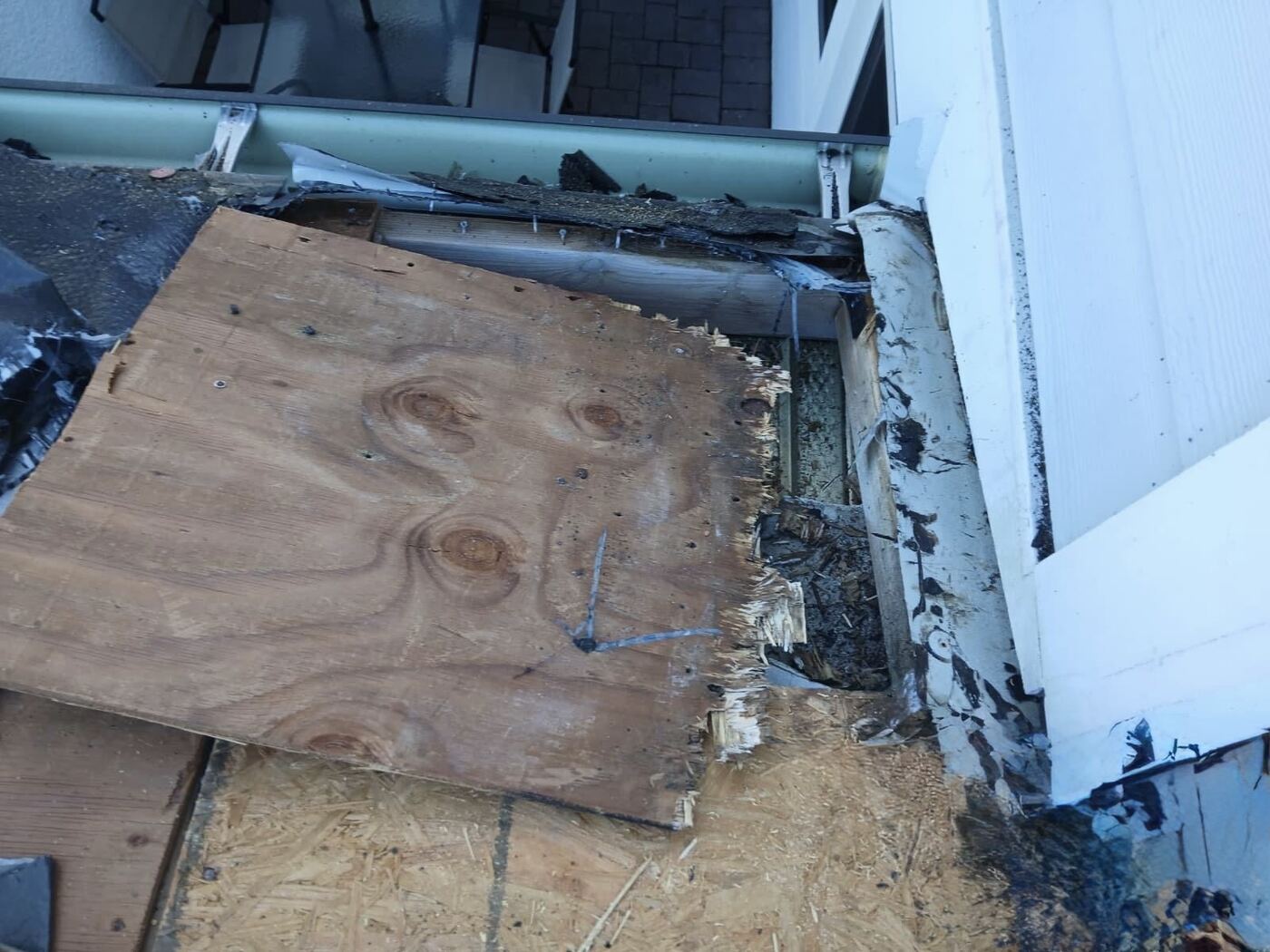 Rotted roof decking exposed during leak repair