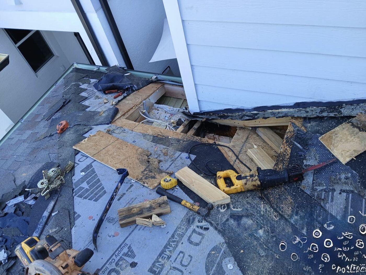 Active repair with rotted decking exposed at wall