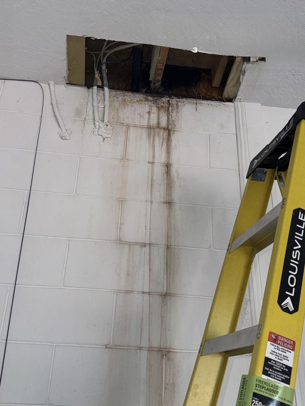 Interior ceiling access cut to trace leak path