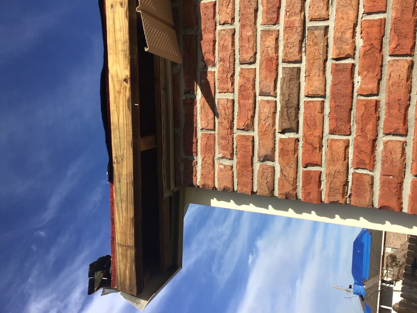 Storm damage exposing brick and framing