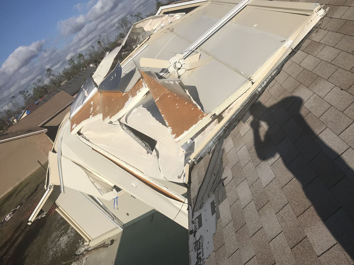 Storm-displaced roofing structure