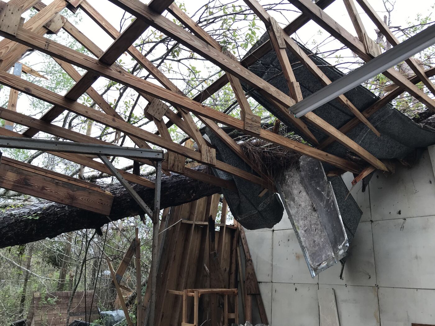 Exposed roof rafters after storm damage