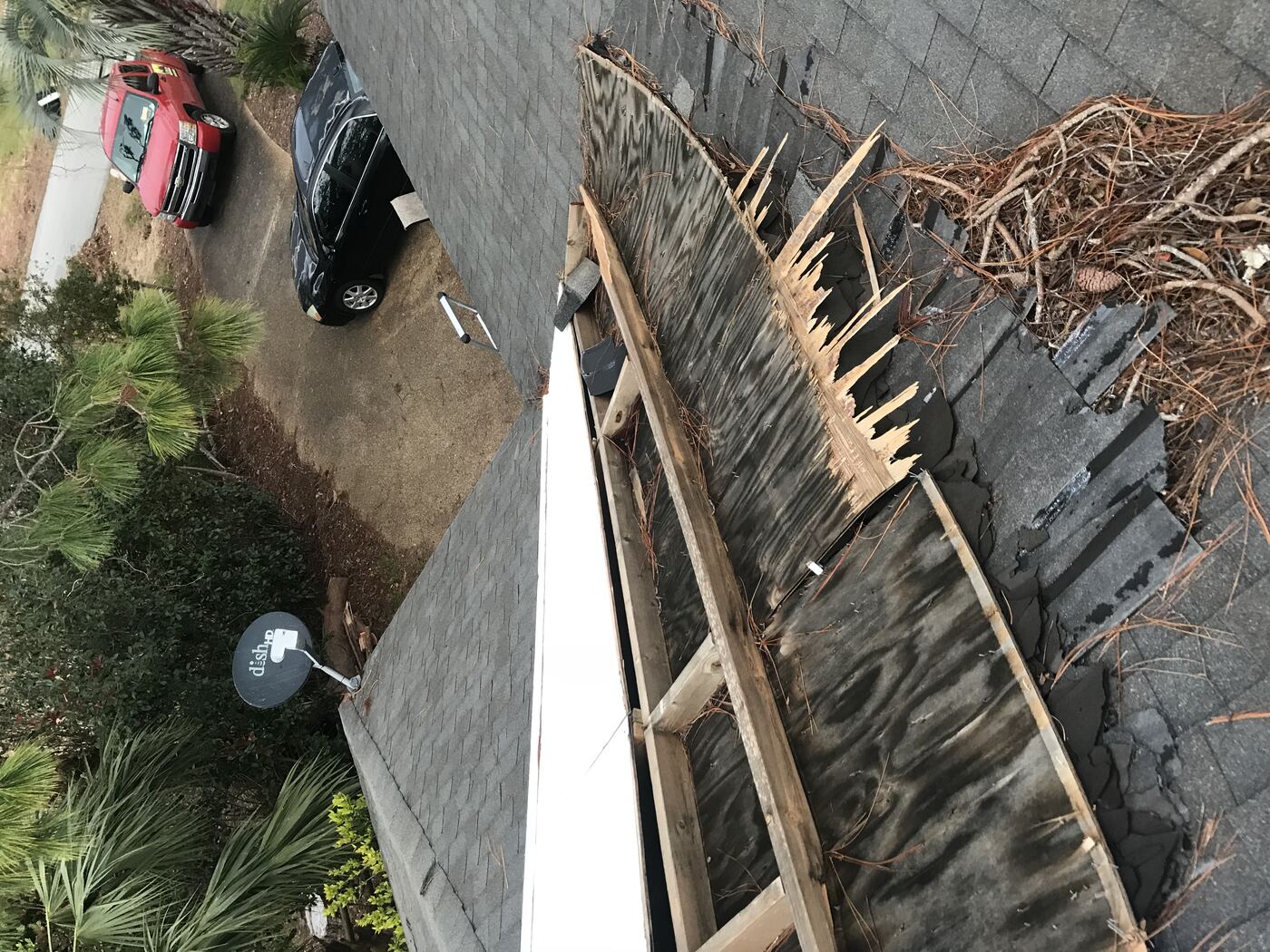 Storm debris on neighboring roof